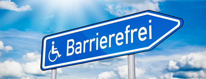 Ein "Straßen" Schild auf dem ein Rollstuhlfahrer zu sehen ist und geschrieben steht Barrierefreiheit.